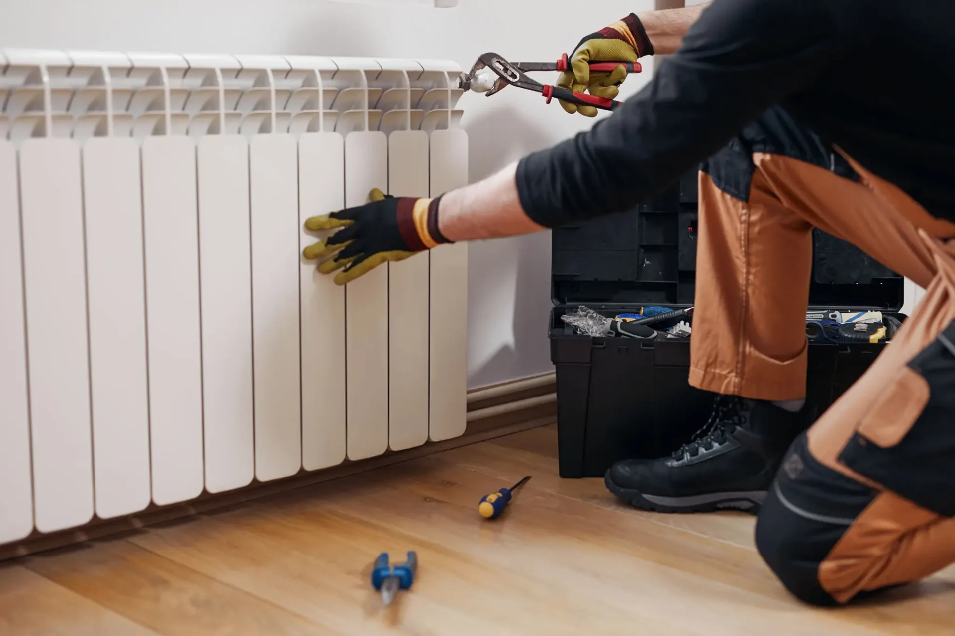 Technician repairing white home radiator