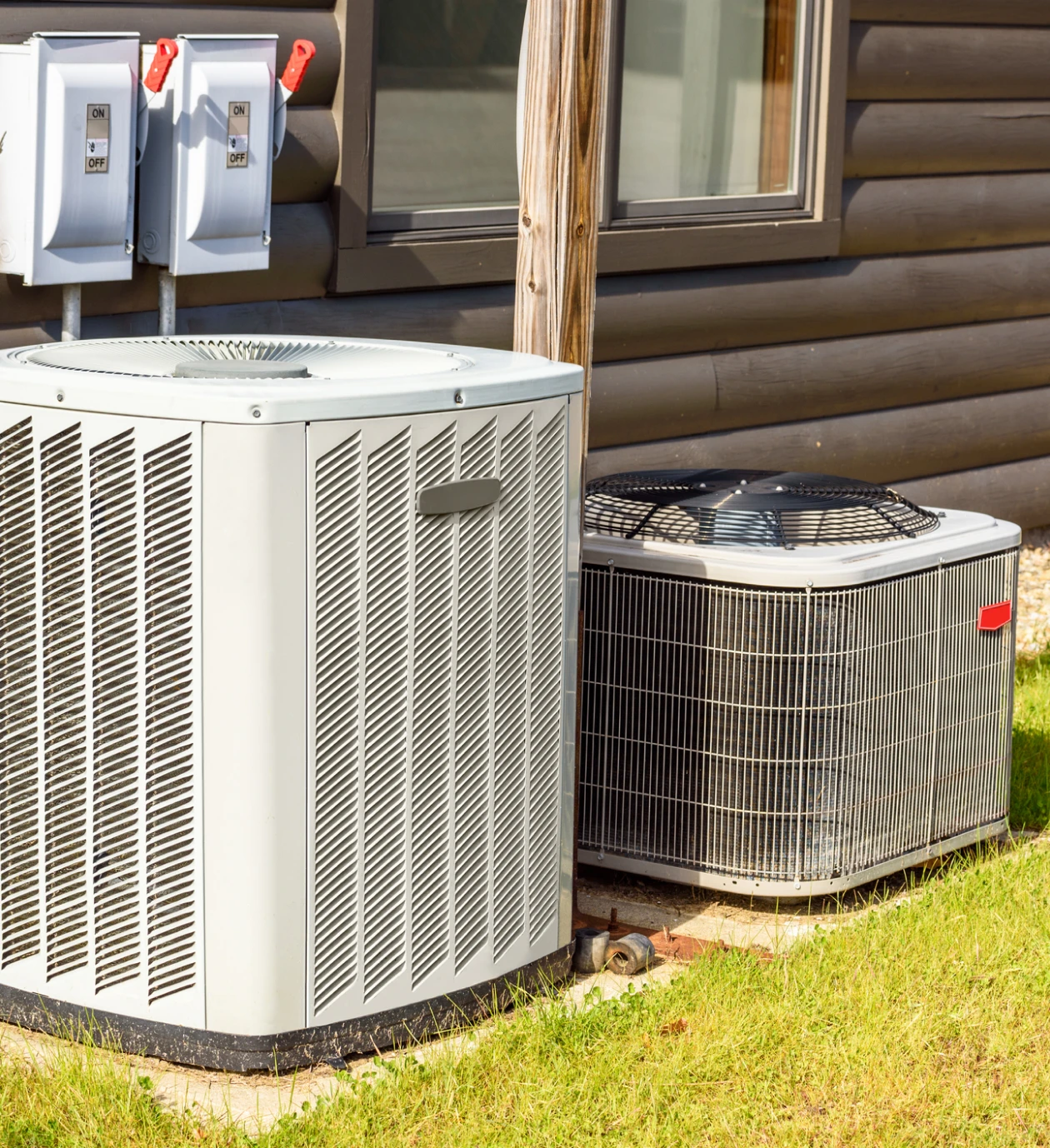 Two HVAC units on grassy area