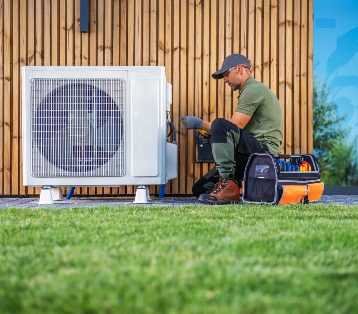Technician repairing outdoor air conditioning unit