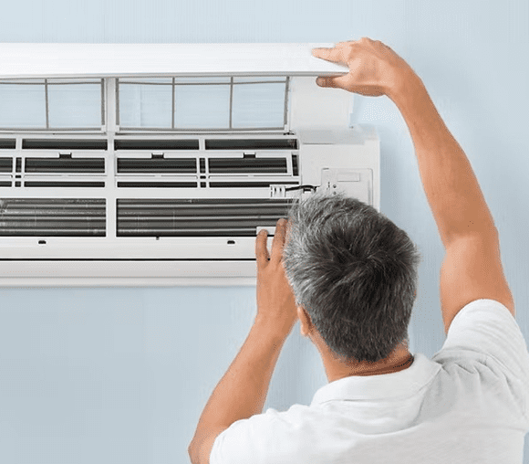 Man repairing air conditioning unit
