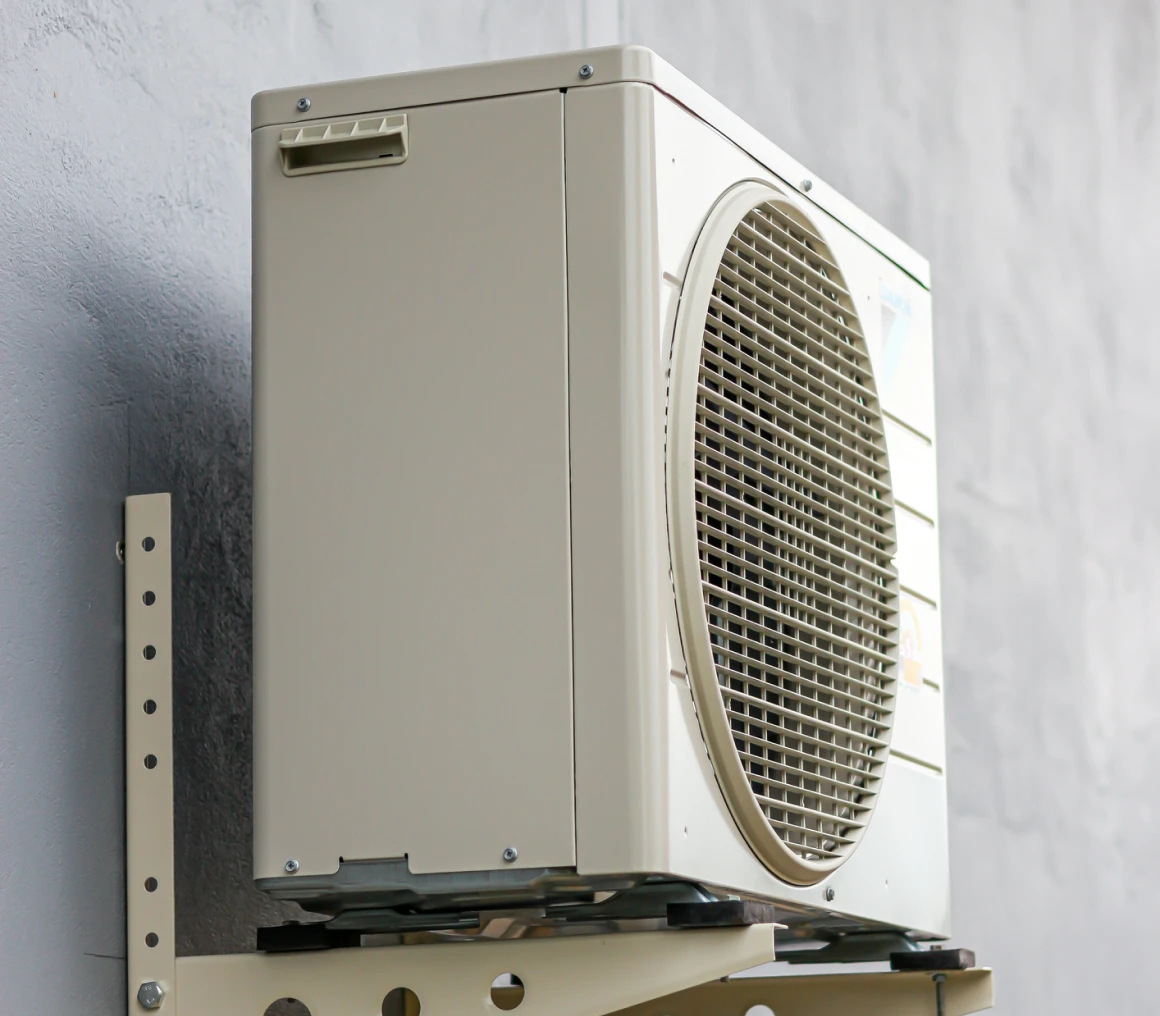Beige air conditioner on exterior wall