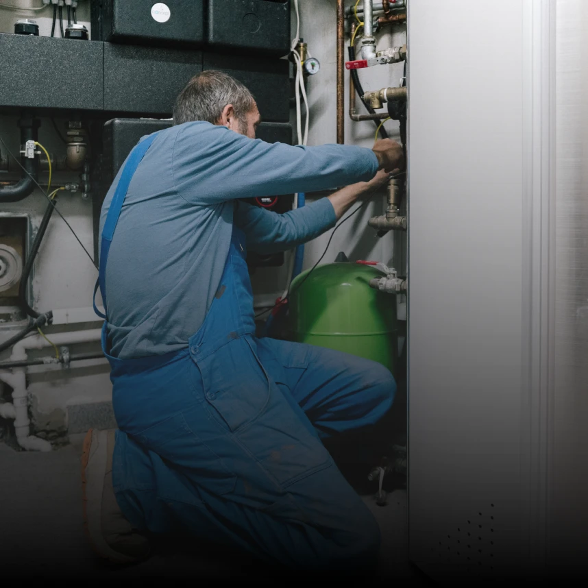 Technician repairing boiler system
