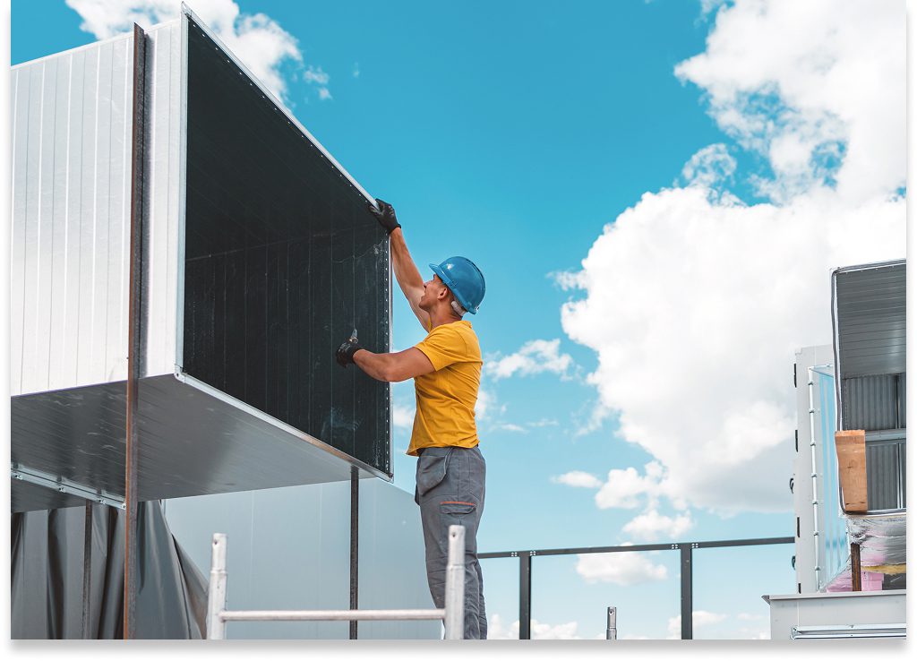 Technician maintaining industrial air duct system