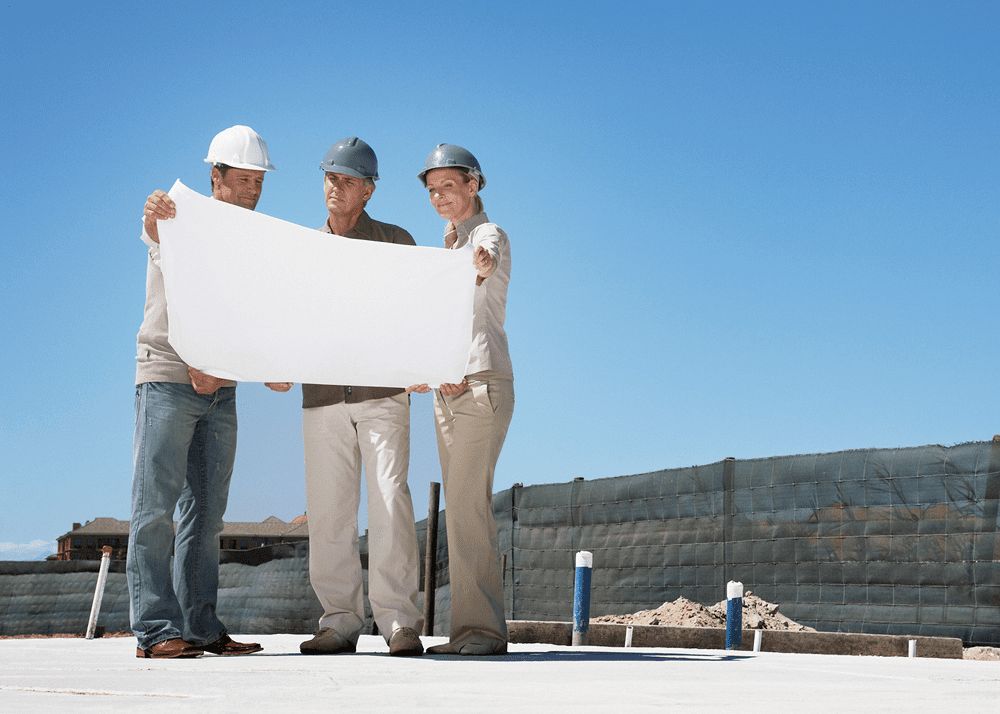 Team discussing project at construction site