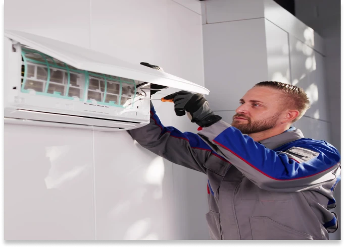 Technician repairing air conditioning unit